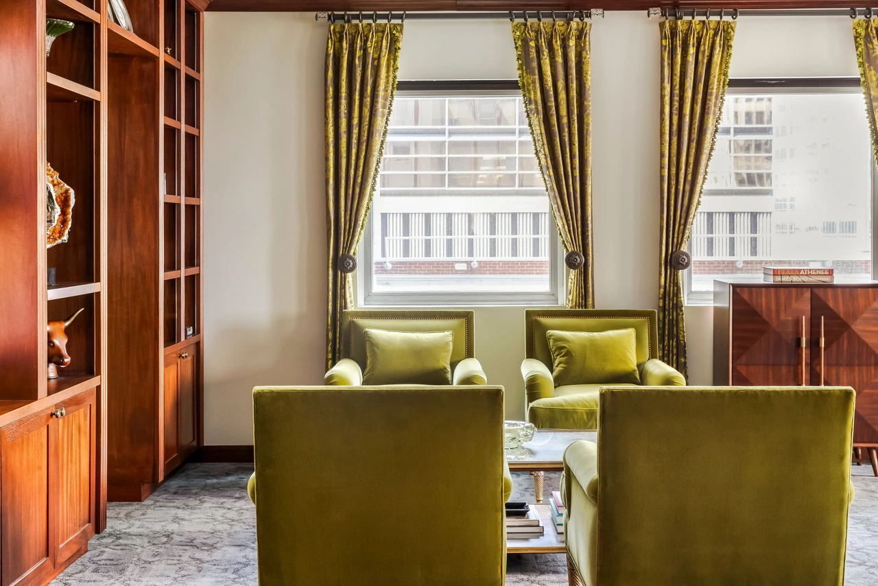 Client lounge with green velvet chairs