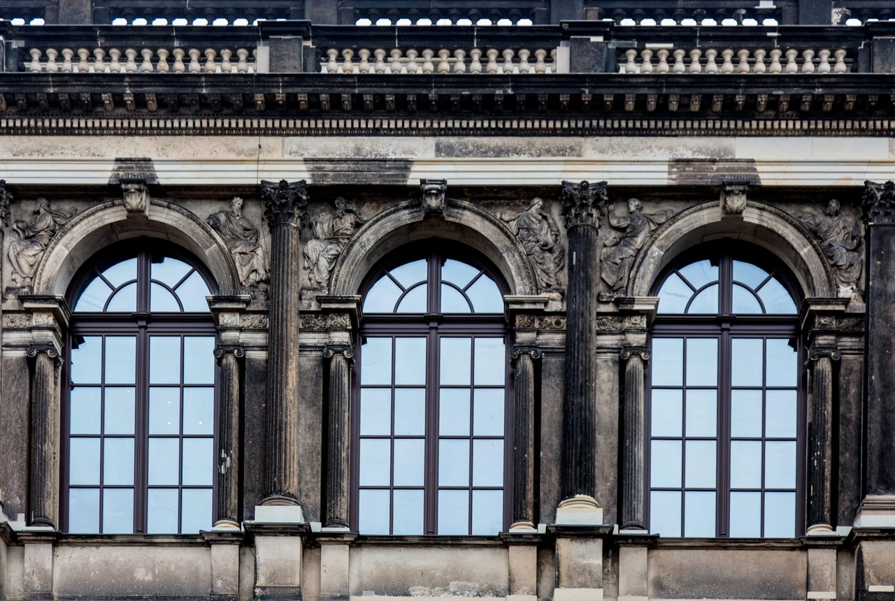 Arched windows on a historic stone facade