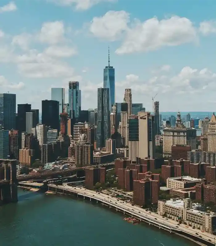 Aerial view of New York City Financial District skyline with skyscrapers and bridges along the East River.