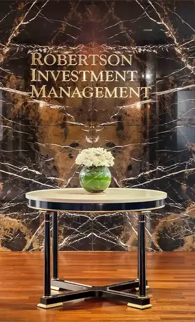 Robertson Investment Management office lobby with marble wall and gold signage in Houston